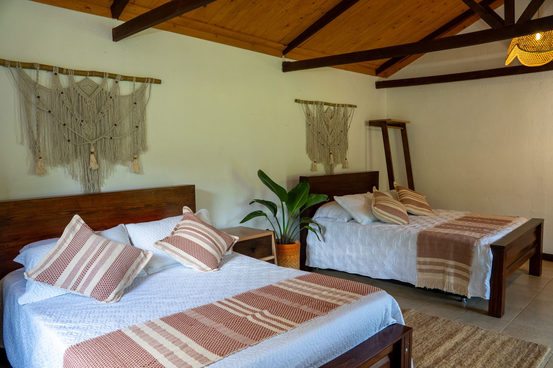 Twin bedroom with vaulted wood ceiling